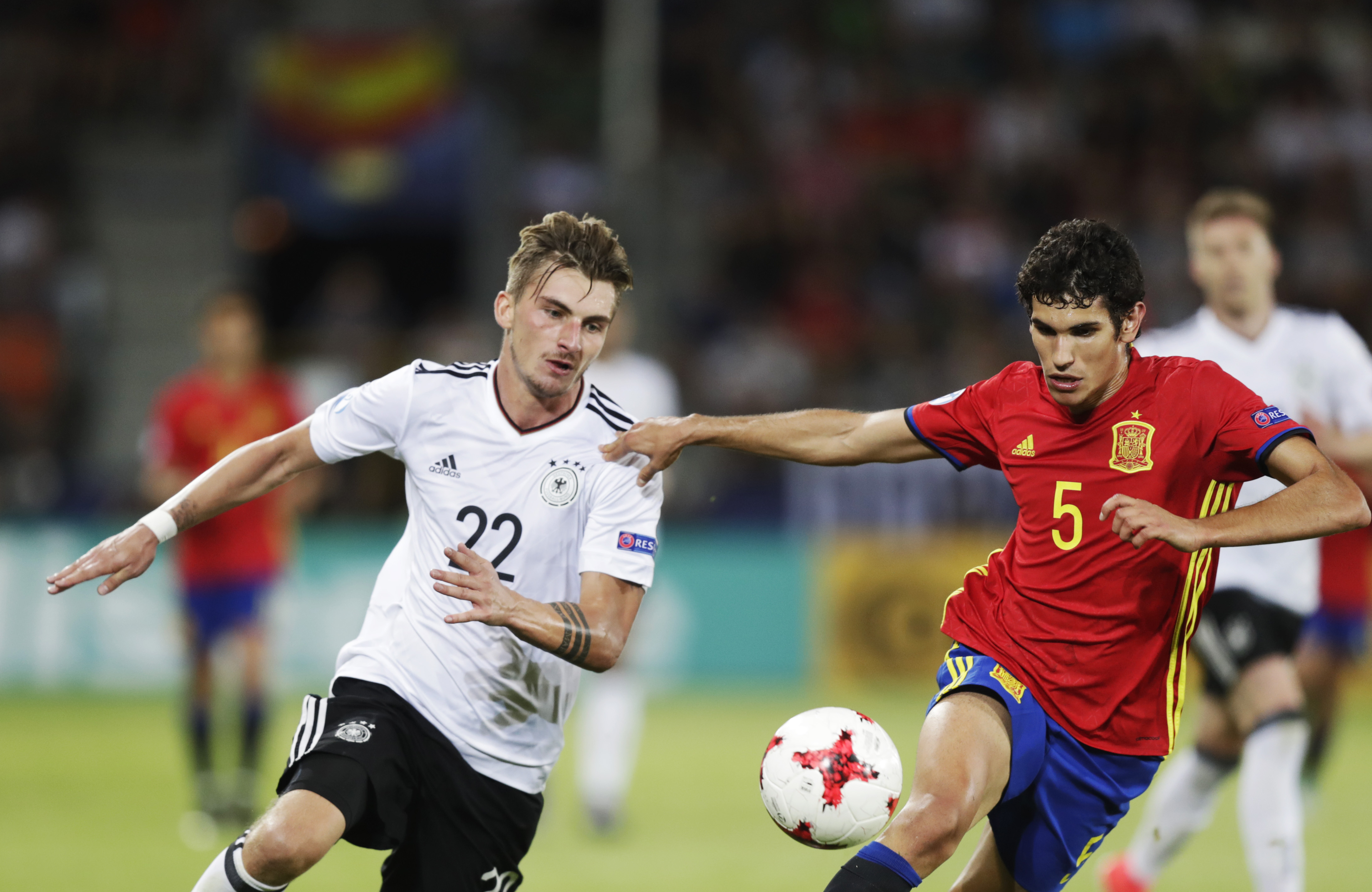 Germany vs spain players in the football ground playing soccer game