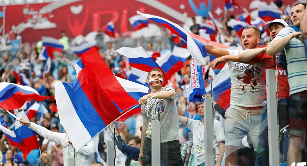 Russia football fans cheer their nation with country flag in world cup tournament